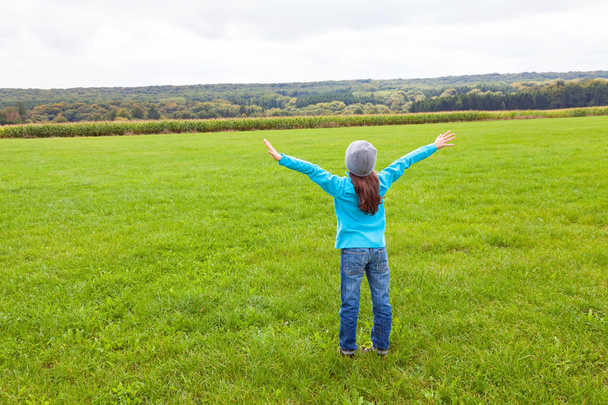 Girl standing in a field - Photo, Image