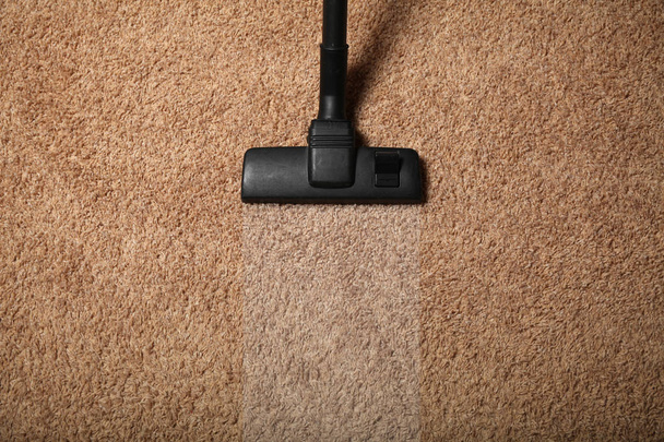 Room cleaning service, vacuum cleaner on dirty carpet. - Valokuva, kuva