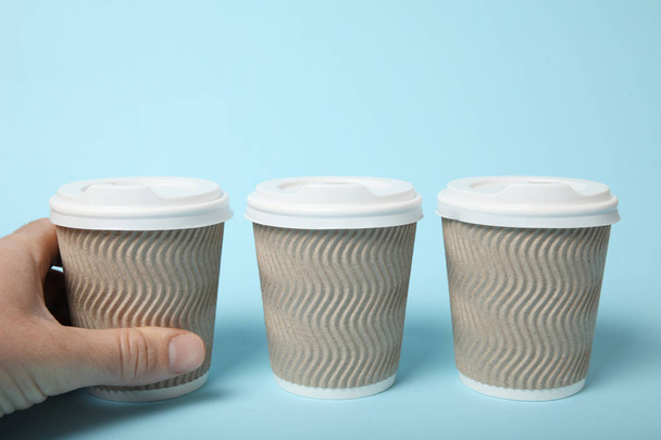 Disposable takeaway coffee in paper cup. - Фото, изображение
