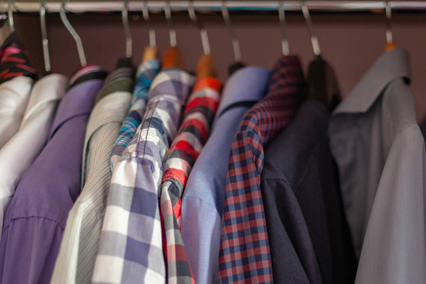 shirts on hangers in the cabinet after ironing and washing - Φωτογραφία, εικόνα