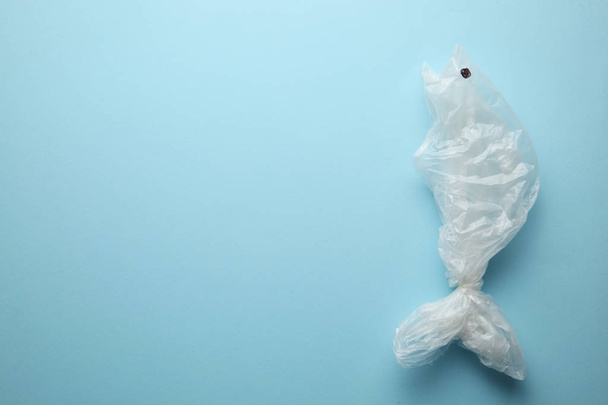 Garbage in the ocean, the silhouette of fish from a plastic bag. - 写真・画像