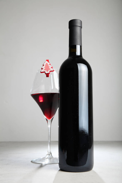 Christmas holidays with a bottle of red wine. - Фото, изображение
