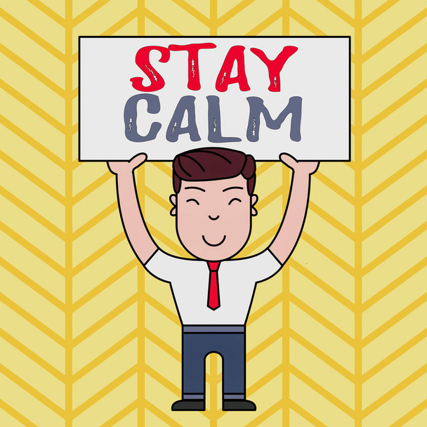 Text sign showing Stay Calm. Conceptual photo Maintain in a state of motion smoothly even under pressure Smiling Man Standing Holding Big Empty Placard Overhead with Both Hands. - Photo, Image