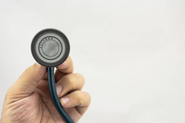 Hand with stethoscope to see the health status of a person - Foto, Imagen