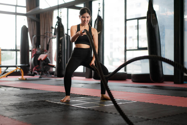 Beautiful Asian Woman with balck battle rope battle ropes exerci - Photo, Image