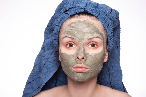 young woman in a towel on her head and mask on her face - Foto, Imagem