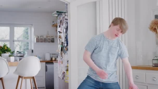 Young Downs Syndrome man having fun dancing at home - shot in slow motion - Metraje, vídeo