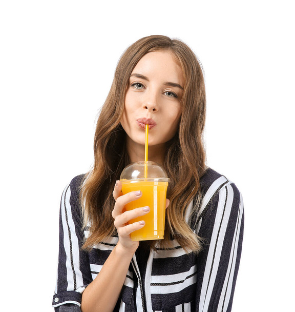 Beautiful young woman with orange juice on white background - 写真・画像
