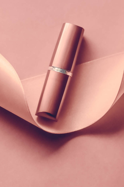 Luxury lipstick and silk ribbon on blush pink holiday background - Foto, Imagen