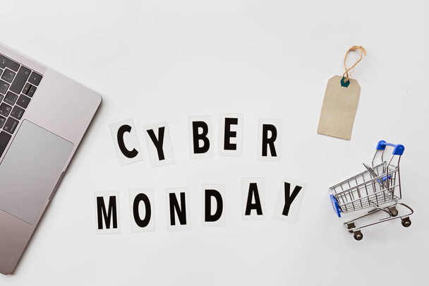 Creative promotion composition Cyber monday text and laptop on white background. Flat lay, top view, overhead, mockup, template. Minimal abstract background. Online shopping, sale, promo. Web banner - Fotoğraf, Görsel