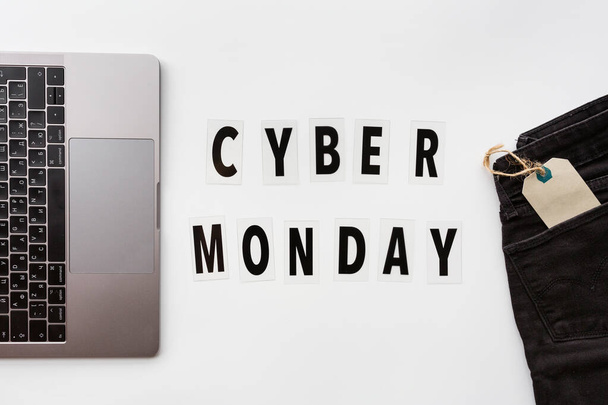 Creative promotion composition Cyber monday text and laptop on white background. Flat lay, top view, overhead, mockup, template. Minimal abstract background. Online shopping, sale, promo. Web banner - Photo, Image