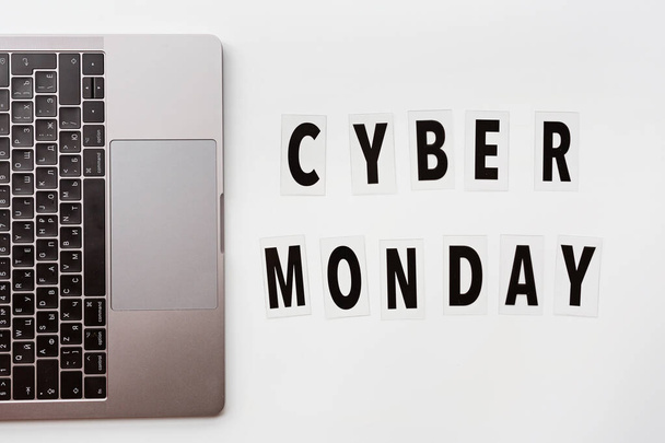Creative promotion composition Cyber monday text and laptop on white background. Flat lay, top view, overhead, mockup, template. Minimal abstract background. Online shopping, sale, promo. Web banner - Fotoğraf, Görsel