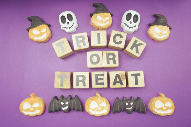 Halloween concept flat lay Trick or Treat alphabet letters on purple background - Photo, Image