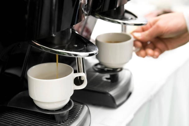 Detail of two espresso coffee machines making coffee. - Foto, imagen