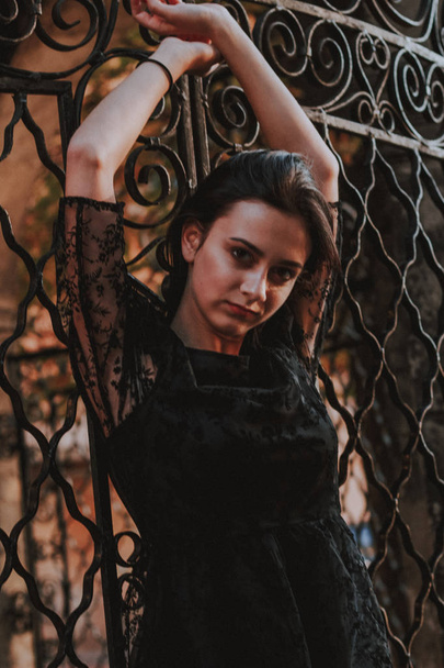 Black-haired girl. Black lace dress. Model shooting. Fashion and - Фото, изображение