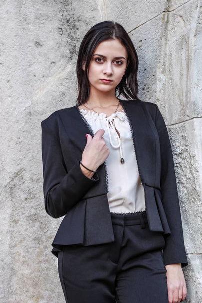 Black haired girl.Business woman in black classic suit.White blo - Фото, зображення