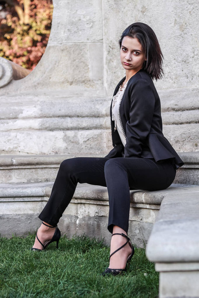 Black haired girl.Business woman in black classic suit.White blo - Foto, Bild