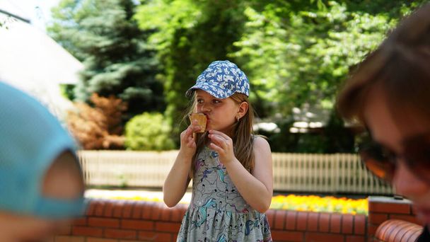 Portrait of a little girl . A child in the Park with ice cream. - Photo, Image