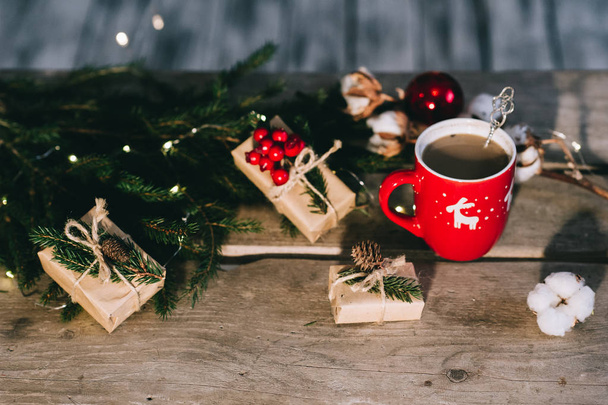 Cup of coffee with christmas decorations on wooden table. - Φωτογραφία, εικόνα