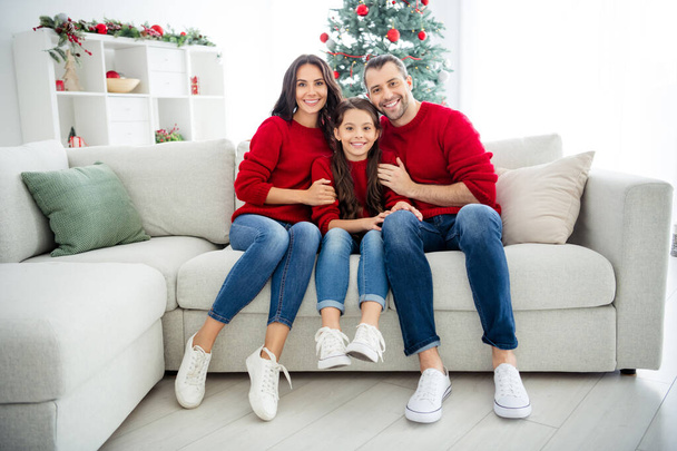 Portrait of three nice attractive lovely idyllic careful cheerful cheery affectionate glad family sitting on divan celebrating newyear eve noel winter vacation light white interior living-room - Foto, immagini
