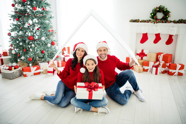 Portrait of three attractive lovely cheerful cheery delighted family celebrating newyear loan purchase real estate credit buying apartment owners ownership mortgage in light white interior living-room - Zdjęcie, obraz