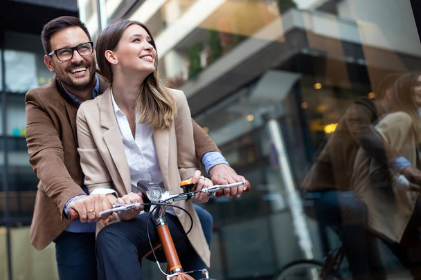 Young happy couple having fun in the city and ride a bicycle - Zdjęcie, obraz