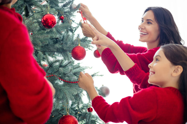 Portrait of nice attractive lovely sweet charming cute cheerful cheery careful kind idyllic family celebrating newyear domestic winter tradition in light white interior over background - Foto, Imagem