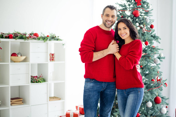 Portrait of charming married couple feel romance hug enjoy christmas time x-mas holidays in house with newyear decoration indoors - Foto, Imagem
