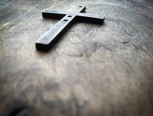 Old cross on a wood background. Wooden Christian Cross. - Photo, Image