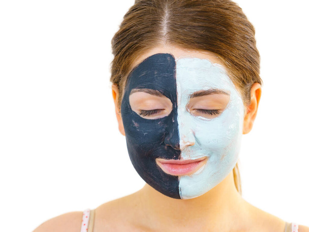 Girl with black white mud mask on face - Foto, Imagen