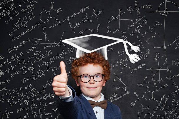 Little boy in graduation hat and glasses. Smart child on science background - Photo, Image