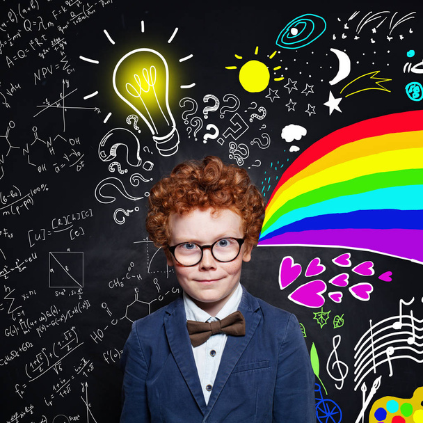 Handsome child boy with lightbulb on scetch background.  - Photo, Image