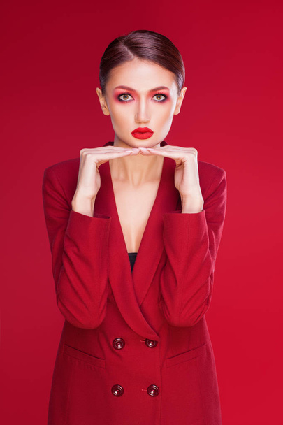 sexy and stylish woman isolated on red - Foto, Imagen