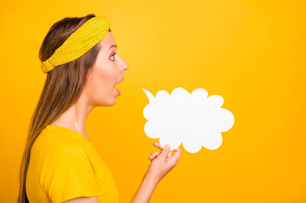 Profile side photo of astonished lady holding paper card cloud sharing novelty isolated over yellow background - Fotó, kép