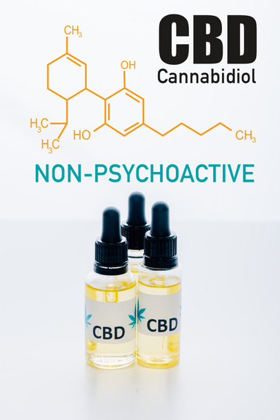 cbd oil in bottles isolated on white with non-psychoactive cbd illustration - Photo, Image