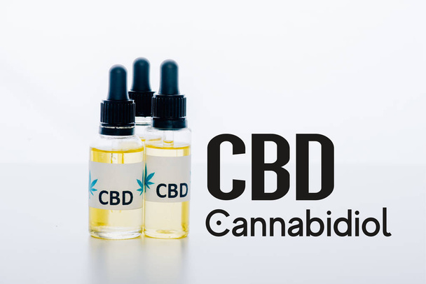 cbd oil in bottles isolated on white with cbd illustration - Foto, afbeelding