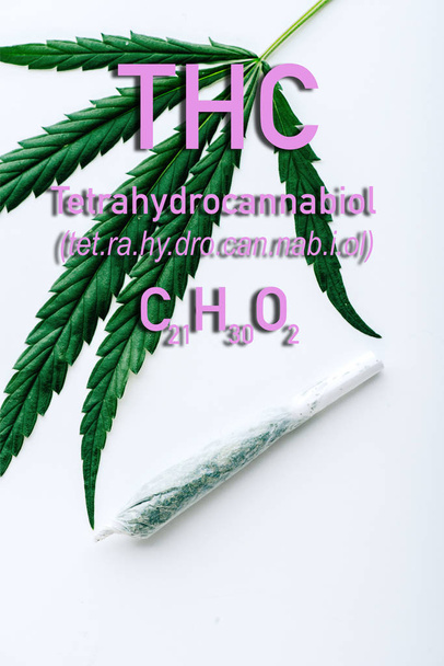 top view of medical marijuana leaf and joint on white background with thc formula illustration - Foto, Imagen