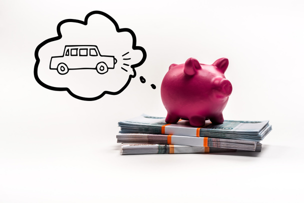 pink piggy bank on stack of russian rubles on white background with car in thought bubble illustration - Photo, Image