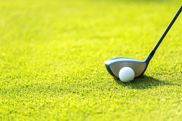 Close up Golf club hitting golf ball along fairway towards green with copy space, green nature background. Lifestyle Concept. - Foto, imagen
