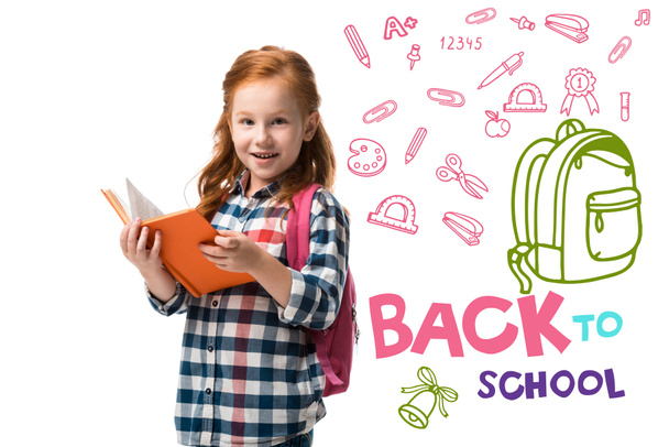 cheerful redhead kid holding orange book near welcome back to school letters isolated on white  - Foto, Bild