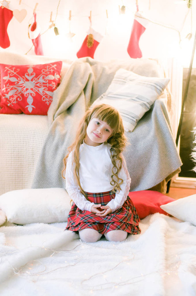 Cute girl with long hair  in the room with Christmas decorations and gifts. Christmas mood - Fotoğraf, Görsel