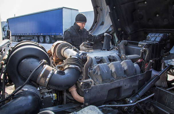 Mechanic repairing the truckTruck Oil service. open cab. - Photo, Image
