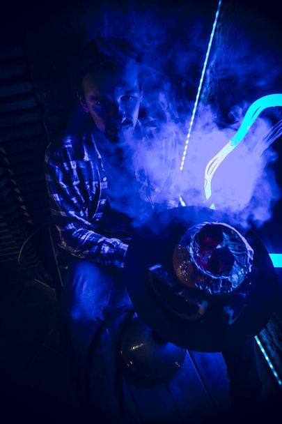 young guy smokes kookah
 - Фото, изображение