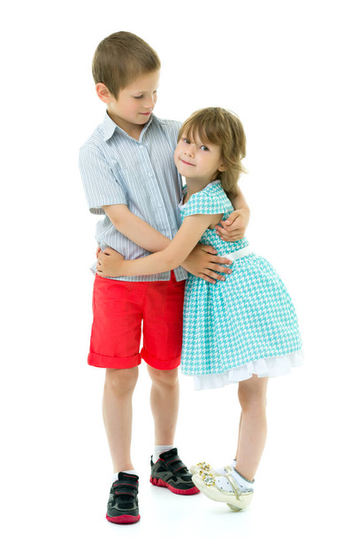 Boy and girl brother and sister gently hug - Fotó, kép