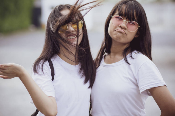 two cheerful asian teenager wearing white shirt - Photo, Image