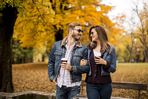 Krásný mladý pár procházky s kávou jít do podzimního parku - Fotografie, Obrázek