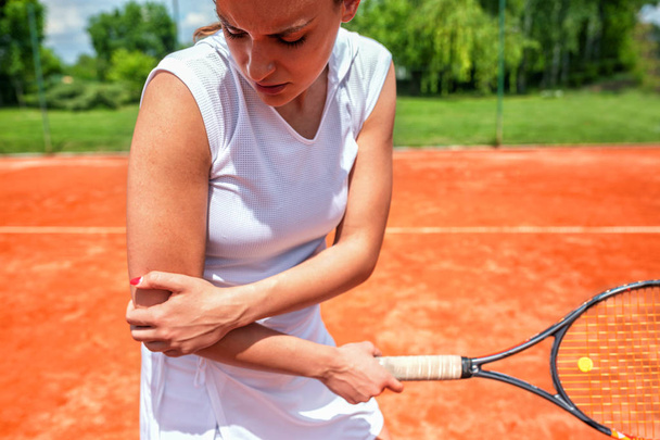 Τραυματισμός αγκώνα στο τένις, δυσάρεστη έκφραση προσώπου - Φωτογραφία, εικόνα