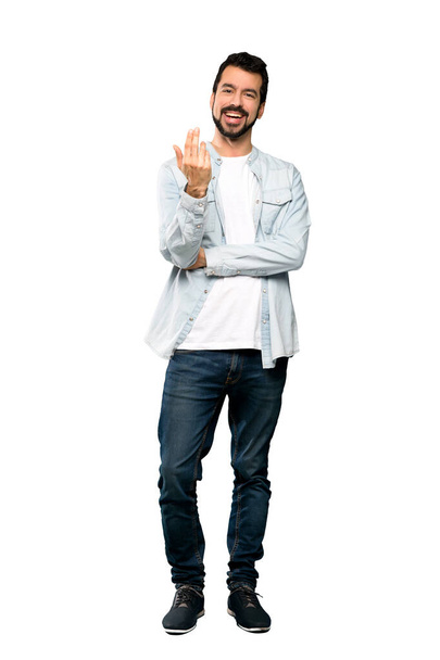 Full-length shot of Handsome man with beard inviting to come with hand. Happy that you came over isolated white background - Fotó, kép