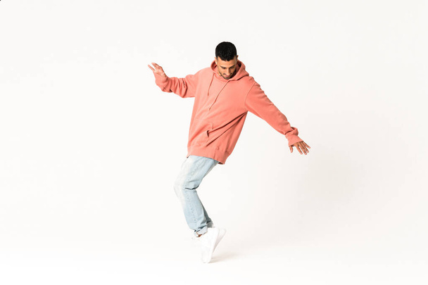 Man dancing street dance style over isolated white background - Foto, Imagen