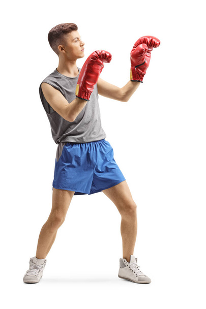 Young guy exercising with boxing gloves  - 写真・画像